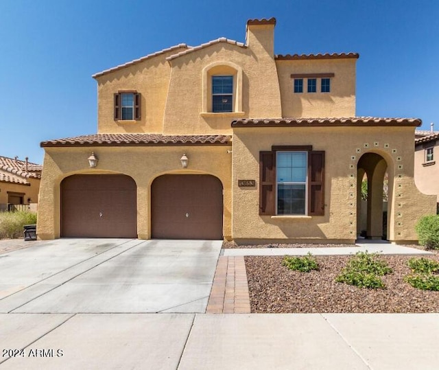 mediterranean / spanish-style house featuring a garage