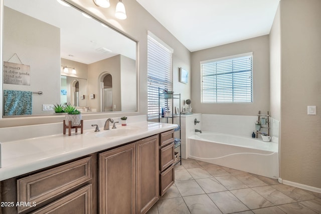 bathroom with vanity, tile patterned flooring, and a tub