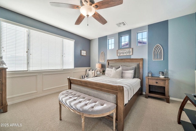 bedroom with ceiling fan and multiple windows