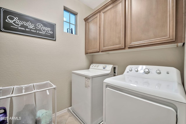 laundry room with washer and dryer and cabinets