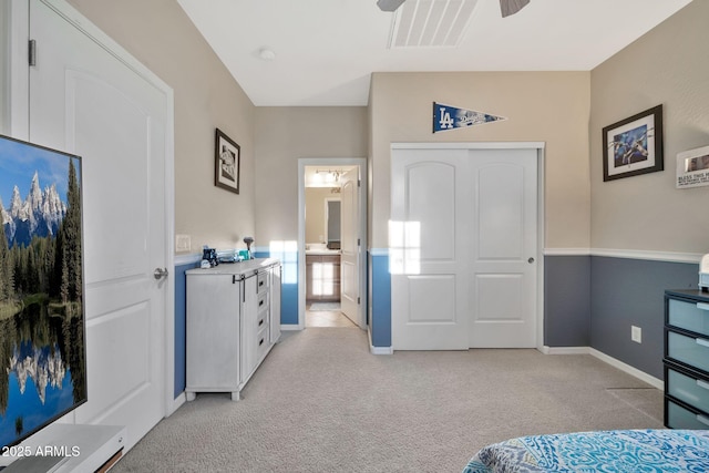 carpeted bedroom with ceiling fan and a closet