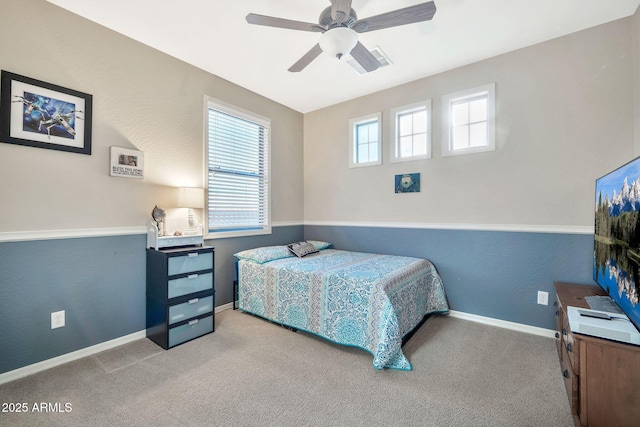 bedroom featuring ceiling fan and light carpet