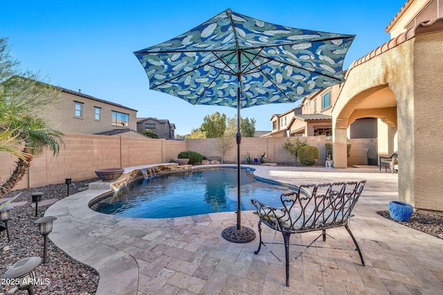 view of swimming pool featuring pool water feature and a patio area