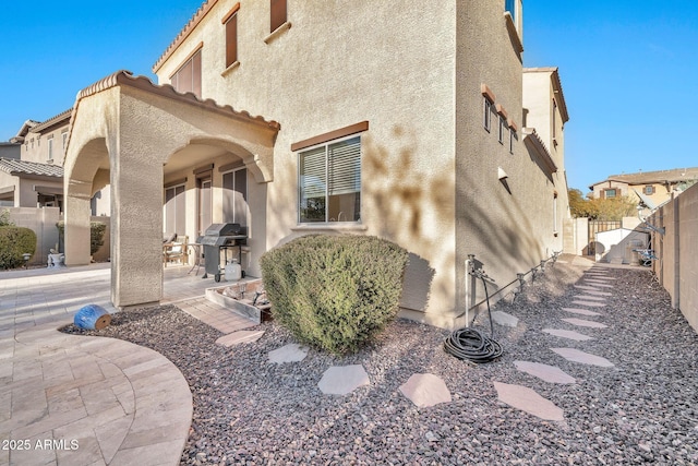 view of property exterior with a patio area