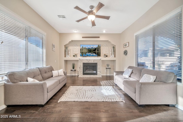 living room with ceiling fan and dark wood-type flooring