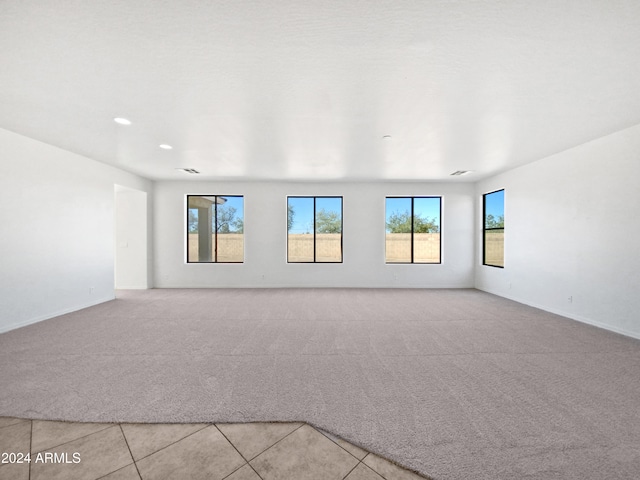 spare room featuring light tile patterned flooring