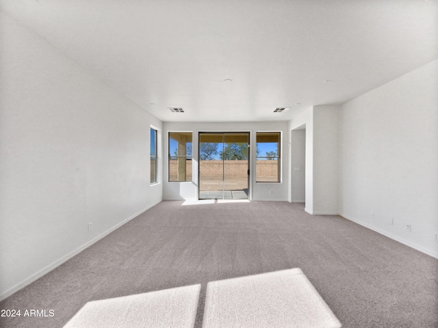 unfurnished room with light colored carpet