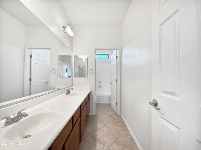 bathroom with toilet, vanity, and tile patterned floors