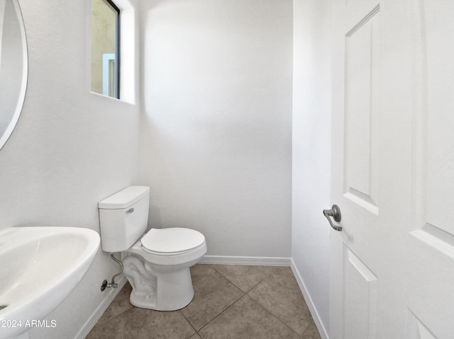 bathroom with tile patterned flooring, toilet, and sink