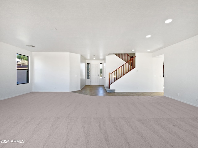 unfurnished living room with light carpet