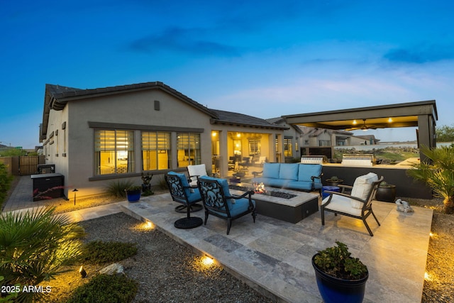 20795 W San Juan Ave, Buckeye, AZ 85396 - back of house with an outdoor living space with a fire pit, a patio, and stucco siding
