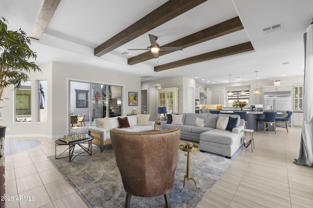 20795 W San Juan Ave, Buckeye, AZ 85396 - living room with light tile patterned flooring, beam ceiling, ceiling fan, and baseboards