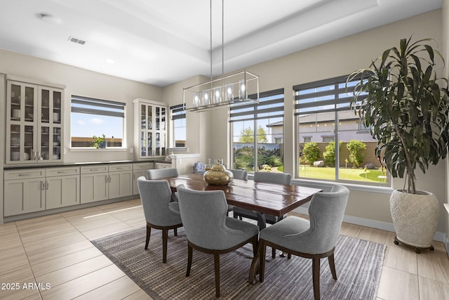 20795 W San Juan Ave, Buckeye, AZ 85396 - dining space featuring healthy amount of natural light, a chandelier, and light tile patterned flooring