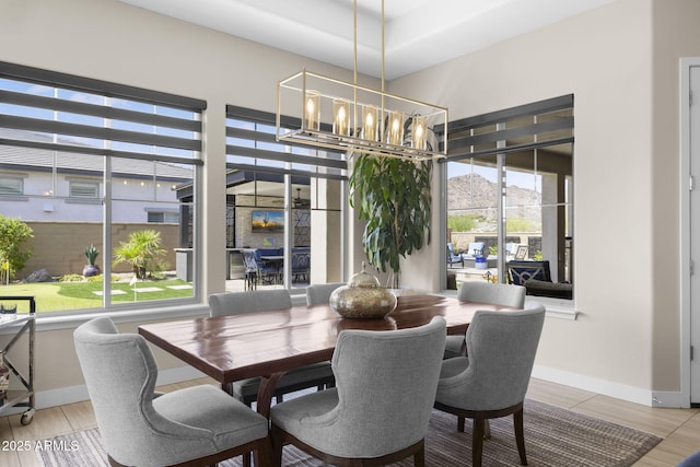 20795 W San Juan Ave, Buckeye, AZ 85396 - dining area featuring a chandelier, baseboards, and a mountain view