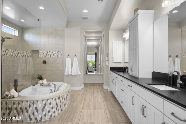20795 W San Juan Ave, Buckeye, AZ 85396 - bathroom featuring vanity, a garden tub, baseboards, recessed lighting, and a tile shower
