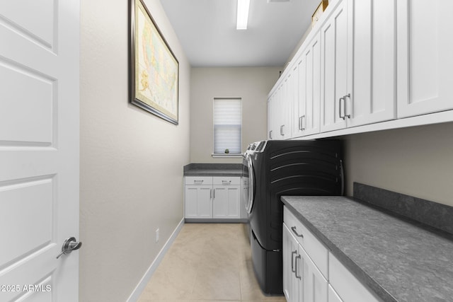 20795 W San Juan Ave, Buckeye, AZ 85396 - laundry area with cabinet space, baseboards, light tile patterned floors, and washer / clothes dryer
