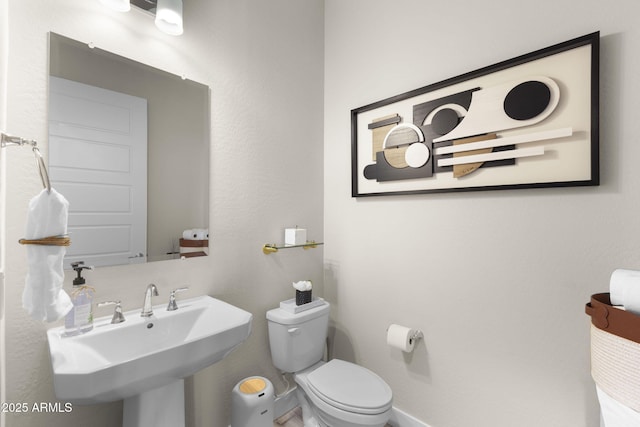 20795 W San Juan Ave, Buckeye, AZ 85396 - half bathroom featuring toilet, a sink, and baseboards