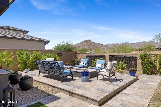 20795 W San Juan Ave, Buckeye, AZ 85396 - fenced backyard with an outdoor hangout area, a mountain view, and a patio area