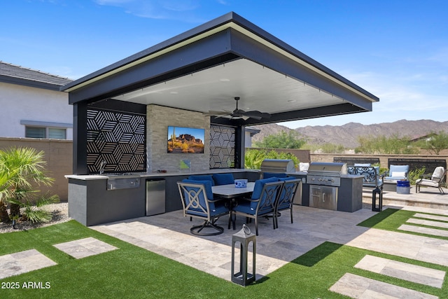 20795 W San Juan Ave, Buckeye, AZ 85396 - view of patio / terrace featuring ceiling fan, a mountain view, and outdoor dining space