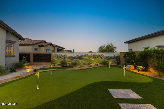 20795 W San Juan Ave, Buckeye, AZ 85396 - yard at dusk featuring a putting area