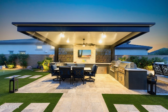 20795 W San Juan Ave, Buckeye, AZ 85396 - fenced backyard with a patio area, a ceiling fan, and outdoor dining space