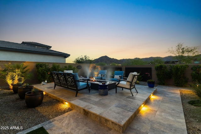 20795 W San Juan Ave, Buckeye, AZ 85396 - view of patio / terrace with an outdoor living space with a fire pit and a mountain view