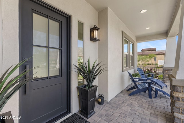 20795 W San Juan Ave, Buckeye, AZ 85396 - view of exterior entry featuring stucco siding and covered porch