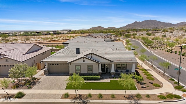 20795 W San Juan Ave, Buckeye, AZ 85396 - view of front of house featuring decorative driveway, a mountain view, a tiled roof, and stucco siding