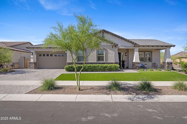 20795 W San Juan Ave, Buckeye, AZ 85396 - craftsman-style house with stone siding, stucco siding, and a front yard