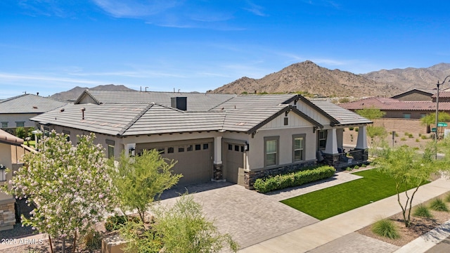 20795 W San Juan Ave, Buckeye, AZ 85396 - view of front of property with a tile roof, an attached garage, decorative driveway, a mountain view, and stucco siding
