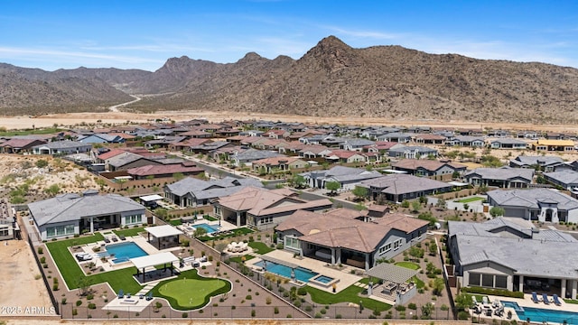 20795 W San Juan Ave, Buckeye, AZ 85396 - aerial perspective of suburban area featuring a pool and a mountainous background