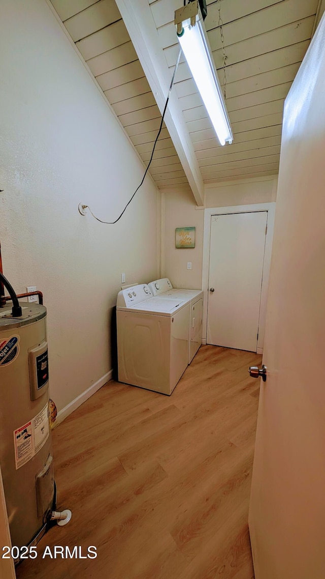 clothes washing area with washer and dryer, wood ceiling, light hardwood / wood-style floors, and electric water heater