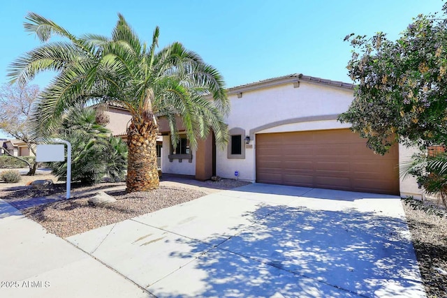 mediterranean / spanish-style home with concrete driveway, an attached garage, and stucco siding