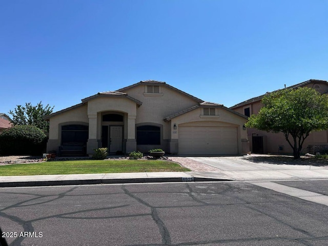 4525 E Runaway Bay Dr, Chandler, AZ 85249 - mediterranean / spanish home with stucco siding, a garage, concrete driveway, and a front lawn