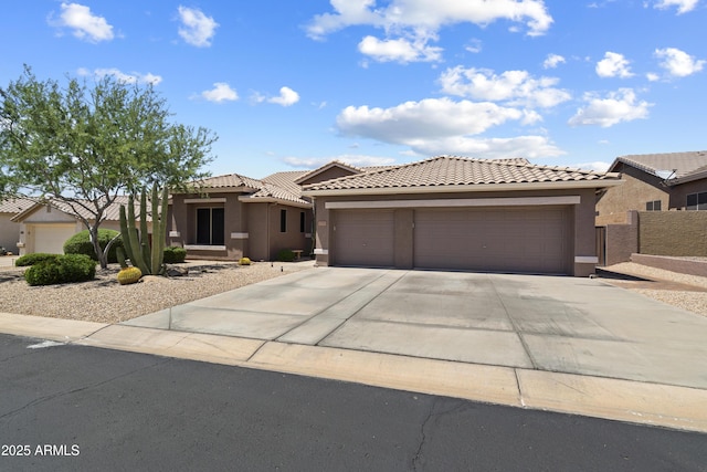 5332 E Thunder Hawk Rd, Cave Creek, AZ 85331 - mediterranean / spanish-style house with an attached garage, concrete driveway, a tile roof, and stucco siding