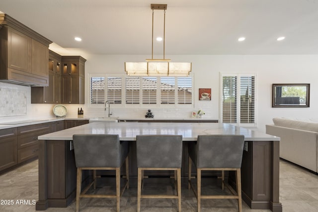 5332 E Thunder Hawk Rd, Cave Creek, AZ 85331 - kitchen with tasteful backsplash, electric cooktop, recessed lighting, glass insert cabinets, and a center island