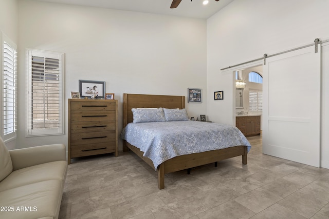 5332 E Thunder Hawk Rd, Cave Creek, AZ 85331 - bedroom featuring a high ceiling, multiple windows, a barn door, ceiling fan, and ensuite bathroom