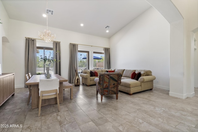 5332 E Thunder Hawk Rd, Cave Creek, AZ 85331 - living room featuring arched walkways, a chandelier, plenty of natural light, and high vaulted ceiling