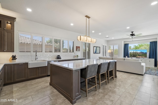 5332 E Thunder Hawk Rd, Cave Creek, AZ 85331 - kitchen featuring a center island, decorative backsplash, stainless steel dishwasher, recessed lighting, and dark brown cabinets