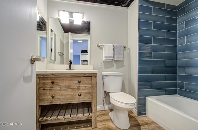 full bath with baseboards, toilet, wood finished floors, and vanity