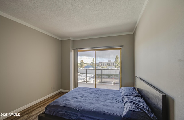 bedroom with access to exterior, baseboards, ornamental molding, wood finished floors, and a textured ceiling