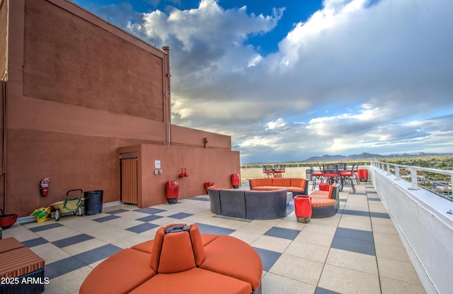 view of patio featuring outdoor dining space, a mountain view, and an outdoor hangout area