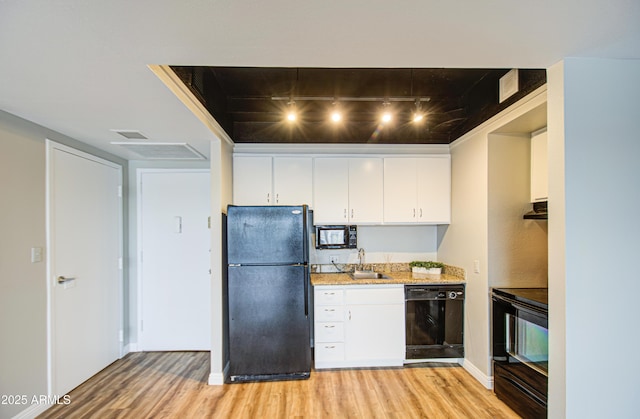 kitchen with light wood finished floors, white cabinets, and black appliances