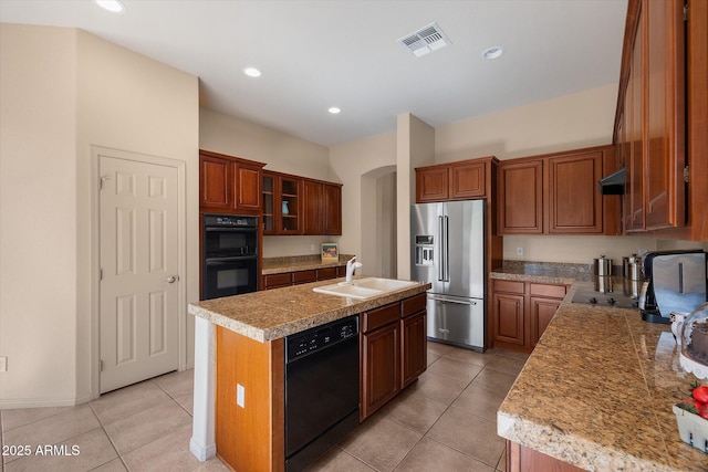 7445 E Eagle Crest Dr Unit 1015, Mesa, AZ 85207 - kitchen featuring black appliances, a sink, arched walkways, light tile patterned flooring, and light countertops