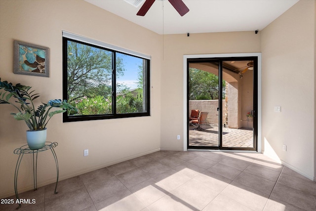 7445 E Eagle Crest Dr Unit 1015, Mesa, AZ 85207 - tiled spare room with healthy amount of natural light, a ceiling fan, and baseboards