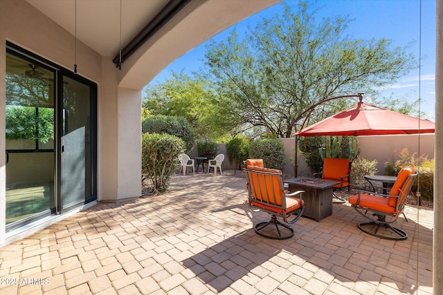 7445 E Eagle Crest Dr Unit 1015, Mesa, AZ 85207 - view of patio / terrace featuring a fire pit and fence