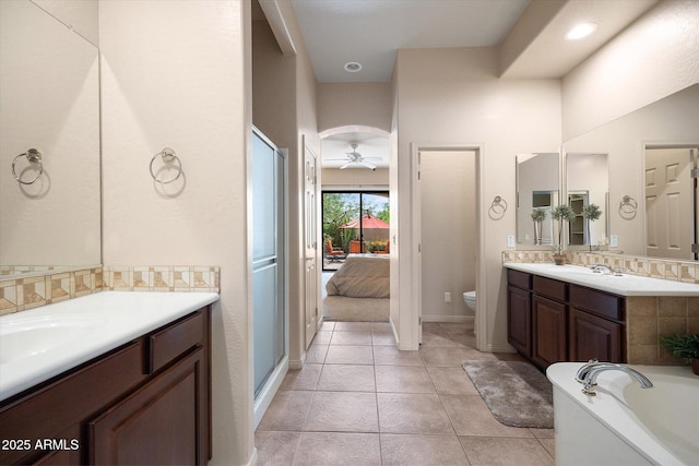 7445 E Eagle Crest Dr Unit 1015, Mesa, AZ 85207 - ensuite bathroom with a ceiling fan, toilet, tile patterned floors, and two vanities