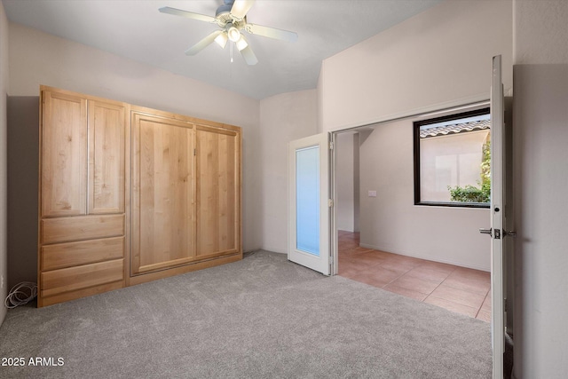 7445 E Eagle Crest Dr Unit 1015, Mesa, AZ 85207 - unfurnished bedroom with light colored carpet, light tile patterned floors, and ceiling fan