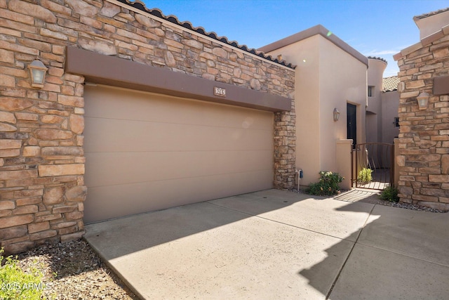 7445 E Eagle Crest Dr Unit 1015, Mesa, AZ 85207 - view of home's exterior with stone siding, stucco siding, and a gate