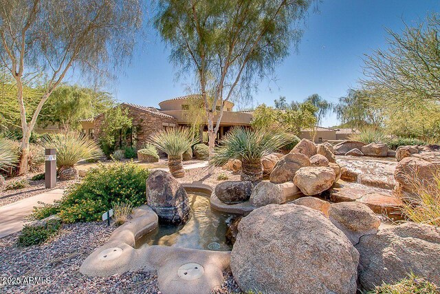 7445 E Eagle Crest Dr Unit 1015, Mesa, AZ 85207 - view of yard featuring a garden pond